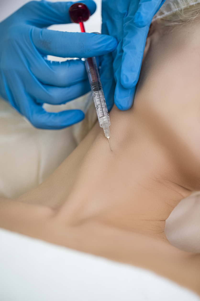 Plastic Surgery Concepts. Closeup Beautician Hands Doing Facial Skin Lifting Injection To Woman’s Neck While Female Posing With Closed Eyes and Receiving Beauty Procedure Indoors.